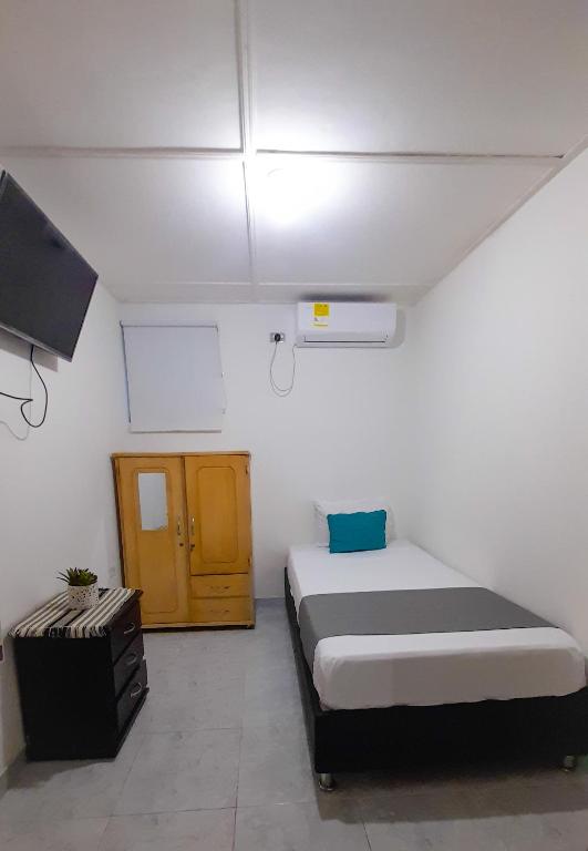 Postel nebo postele na pokoji v ubytování Hotel Poblado Suite