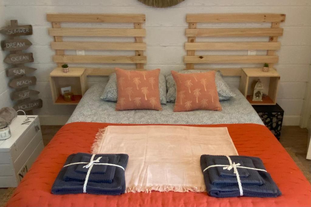 um quarto com uma cama com chinelos azuis em La petite Jeanine em Villers-sur-Mer