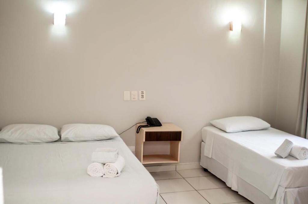 Postel nebo postele na pokoji v ubytování SMART IGUASSU HOTEL