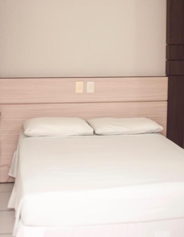 Postel nebo postele na pokoji v ubytování SMART IGUASSU HOTEL