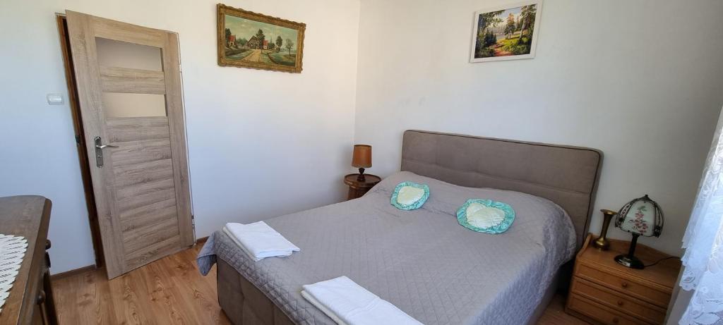a bedroom with a bed with two pillows on it at U Tereni na Mazurach in Kuty