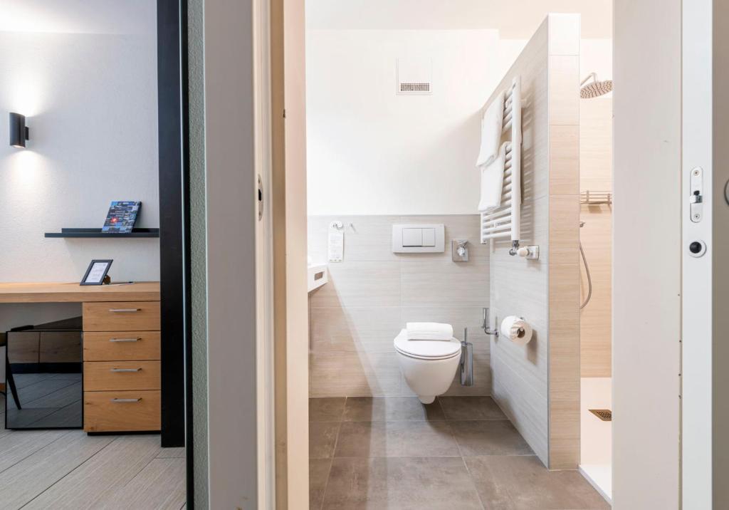 a bathroom with a toilet and a sink and a desk at I Grappoli in Sessa