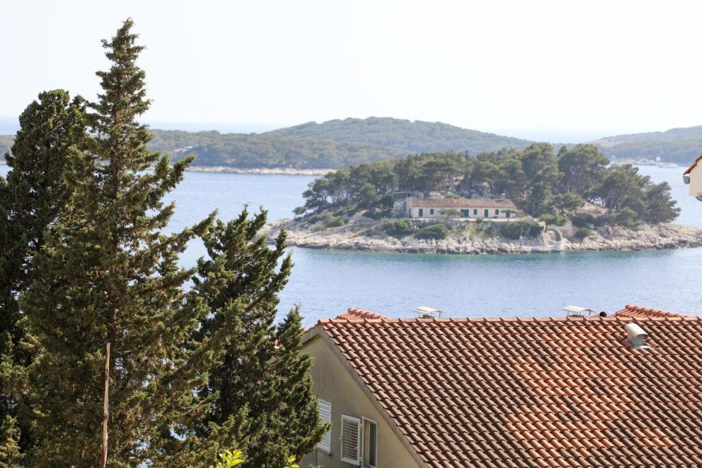 a house on a small island in the water at Adria Apartment in Hvar