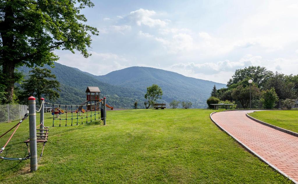 a park with a playground and mountains in the background at I Grappoli in Sessa