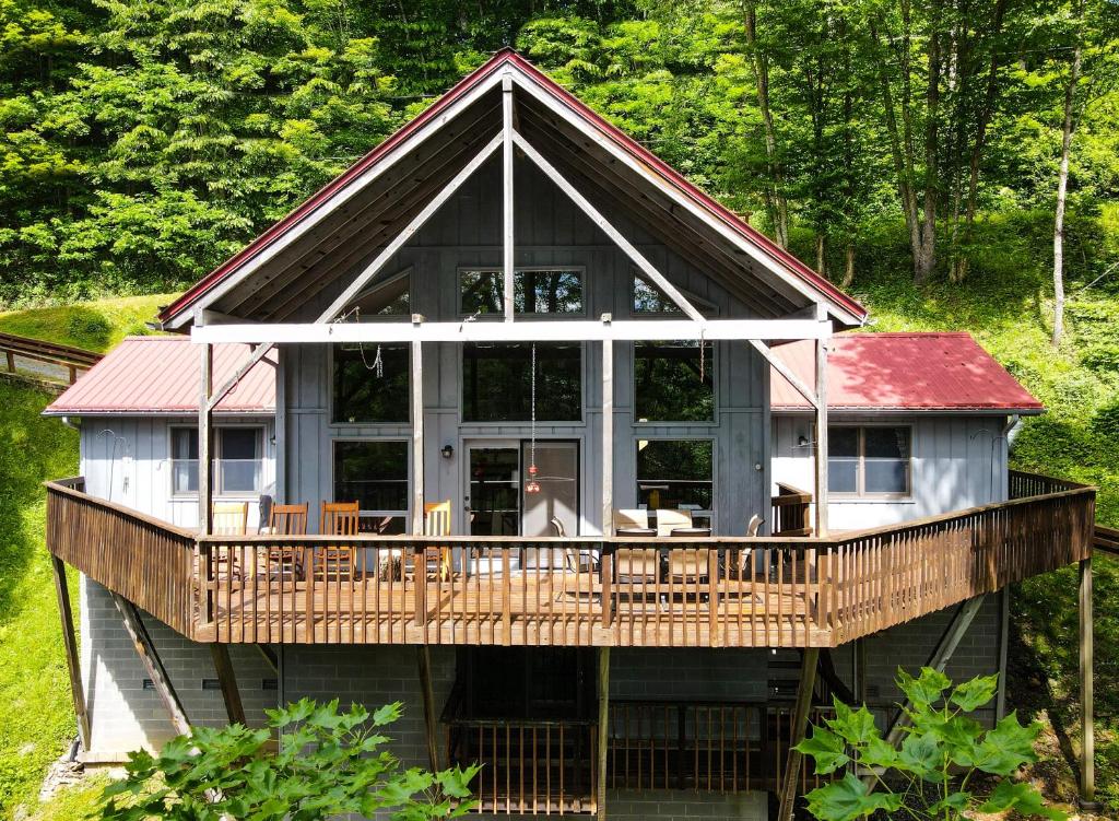 a large house with a large deck in the woods at Wolf Ridge Retreat in Swiss