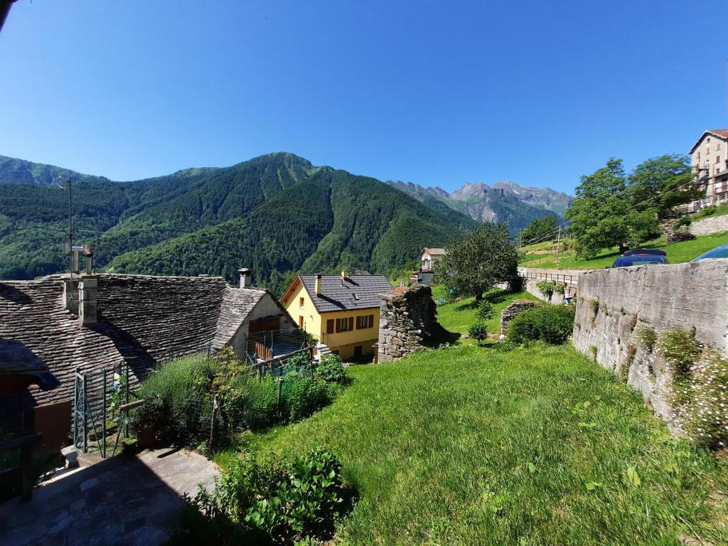 a view of a village with mountains in the background at CasAmici in Bognanco