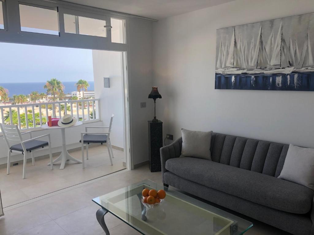 a living room with a couch and a table at Blue Sea View in Puerto del Carmen
