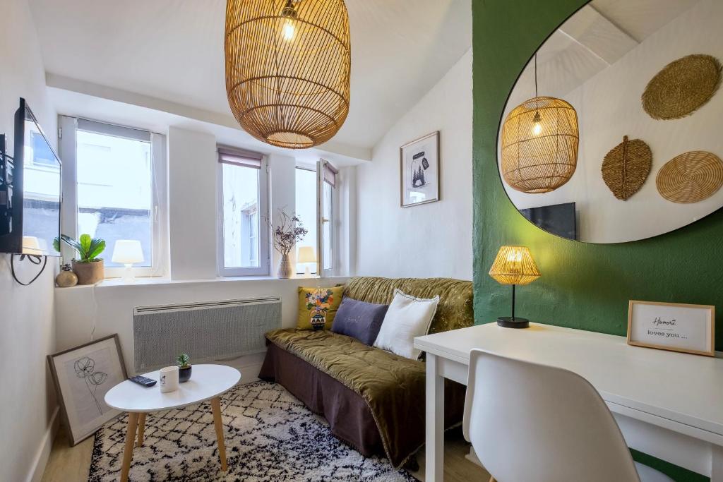 a living room with a couch and a table at HONORÊ SUITE FERRANDIERE in Lyon