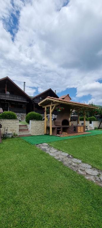 a large building with a green lawn in front of it at Freemont in Braşov