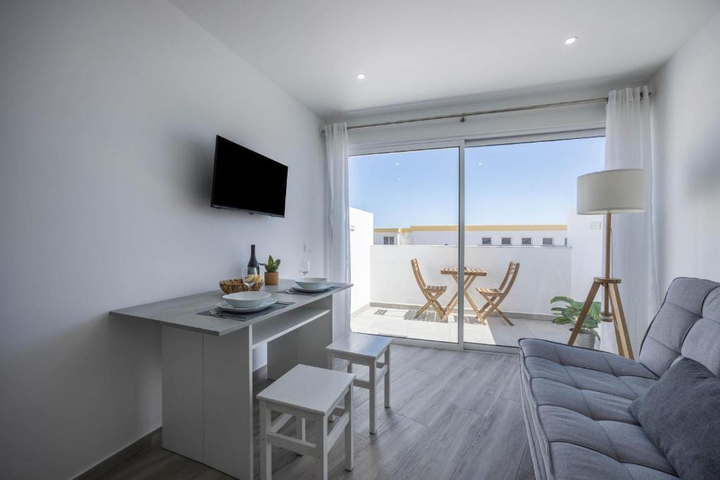 a living room with a couch and a table at Sunset Apartment in Sagres