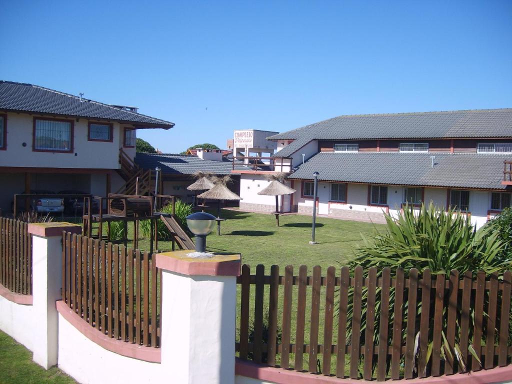 una cerca frente a una casa con un patio en Complejo Valparaiso en Santa Clara del Mar