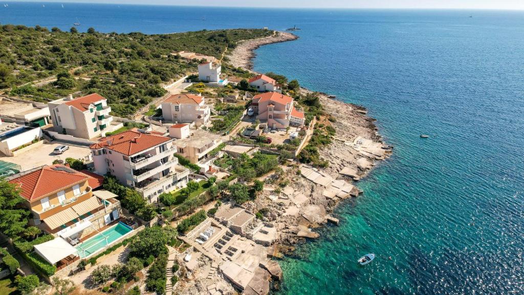 an aerial view of a house on a island in the water at Rajcic Apartments in Rogoznica