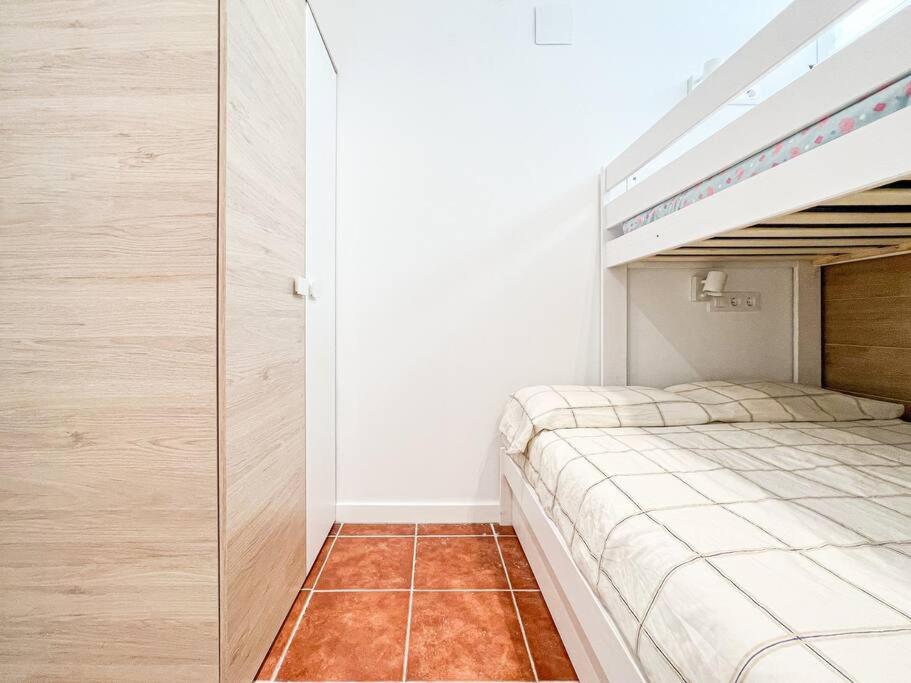 a bedroom with a bunk bed with a ladder at Apartament 'Es Botànic' in Blanes