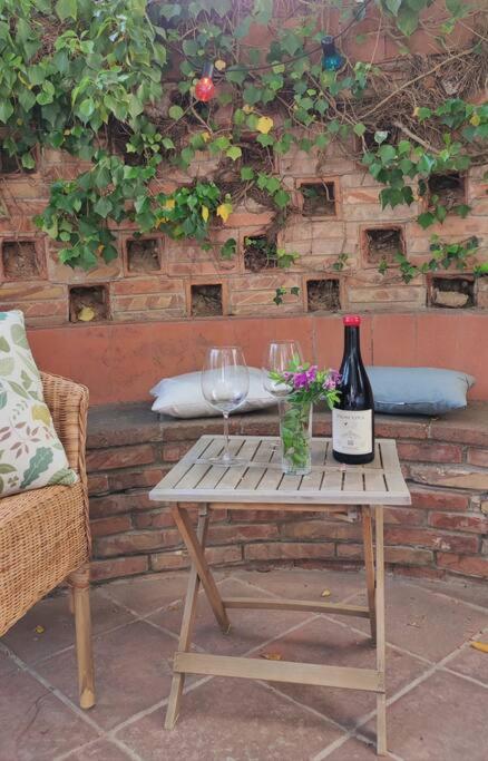 a table with two glasses and a bottle of wine at Apartament 'Es Botànic' in Blanes