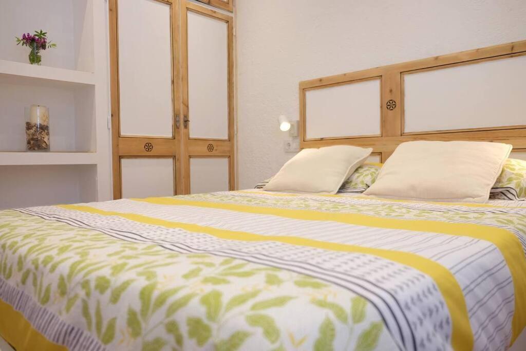 a bedroom with a large bed with two pillows at Apartament 'Es Botànic' in Blanes