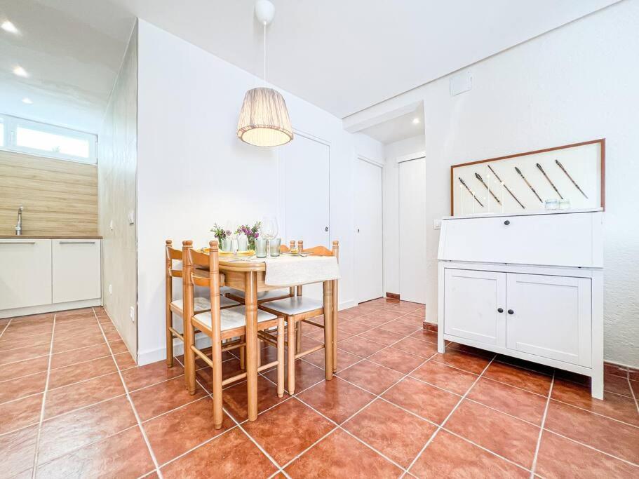 a kitchen and dining room with a table and chairs at Apartament 'Es Botànic' in Blanes