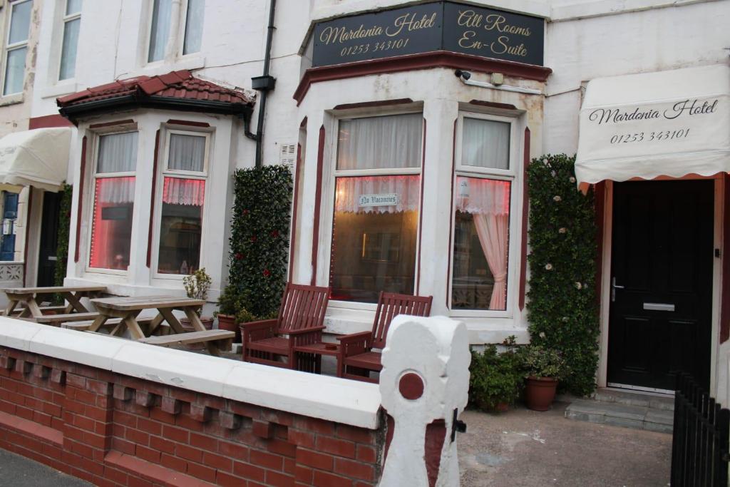 a restaurant with chairs and tables outside of a building at Mardonia Hotel in Blackpool