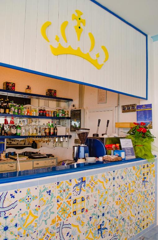 a kitchen with a counter with a crown on the wall at Hotel Regina del Mare in Ischia