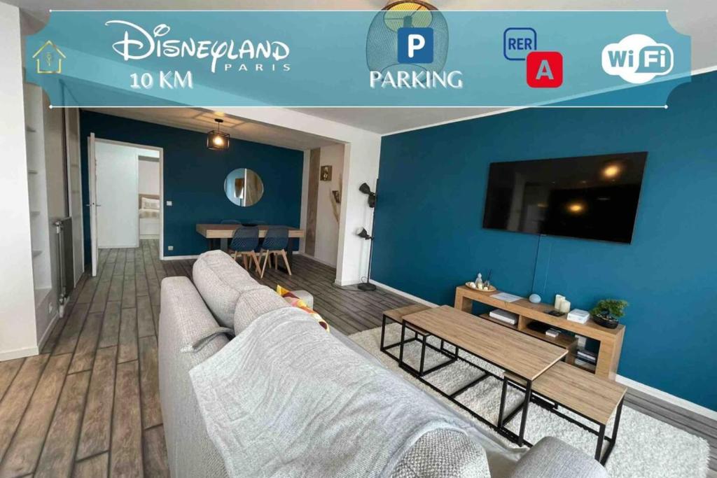 a living room with a couch and a tv at Next to Disney Appart'Hôtel Le Rêve Bleu in Torcy