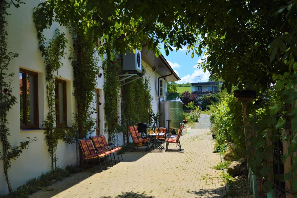 a patio with chairs and a table on the side of a building at Penzion v rodinném vinařství Kadubcovi in Lipov