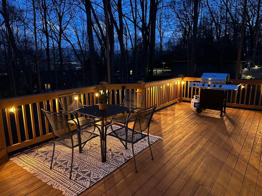a patio with a table and a grill on a deck at Spacious Family Friendly Home Near Massanutten and National Park in McGaheysville