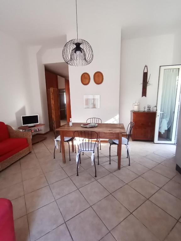 a living room with a wooden table and chairs at Il Poggio in Murlo