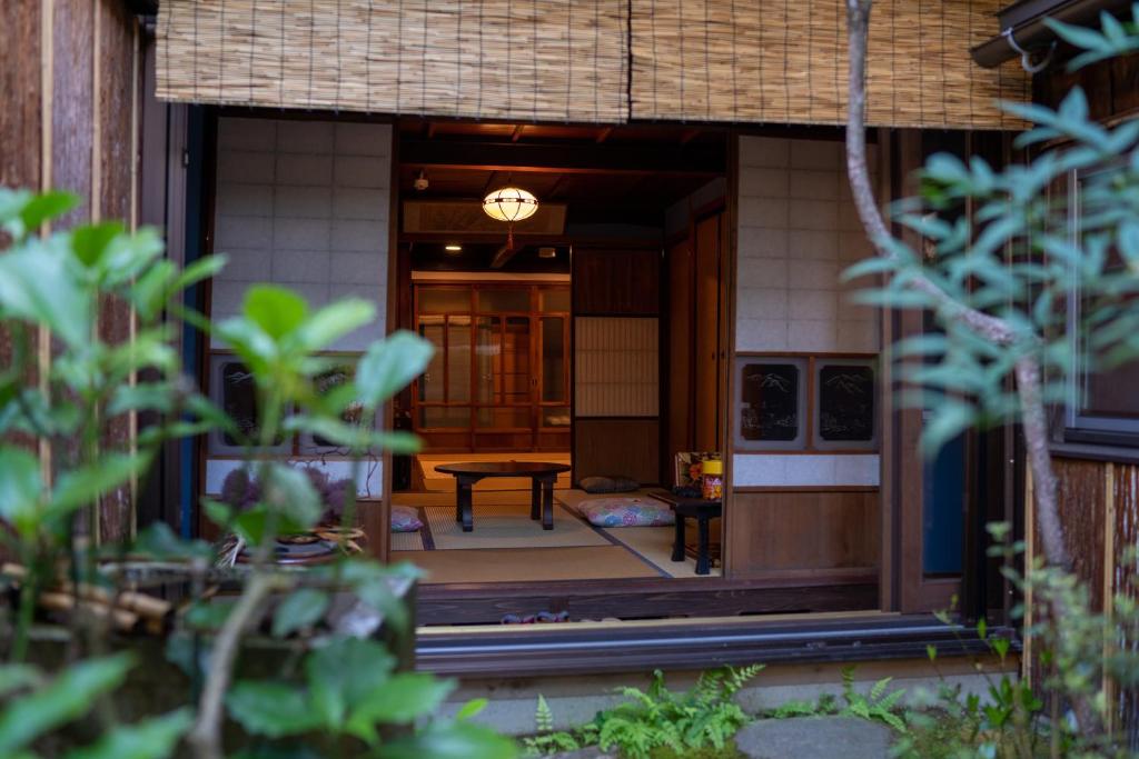 a front door of a house with a table at 金沢町家ゲストハウスかるた in Kanazawa