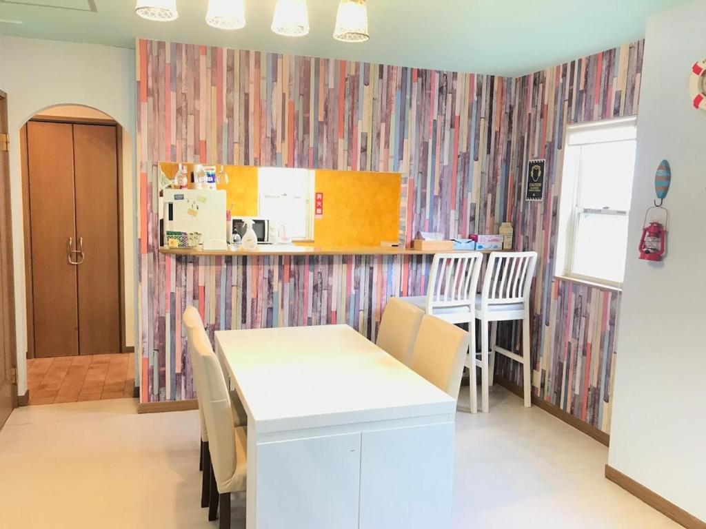 a kitchen and dining room with a table and chairs at Marine House - Vacation STAY 77620v in Koshigoe