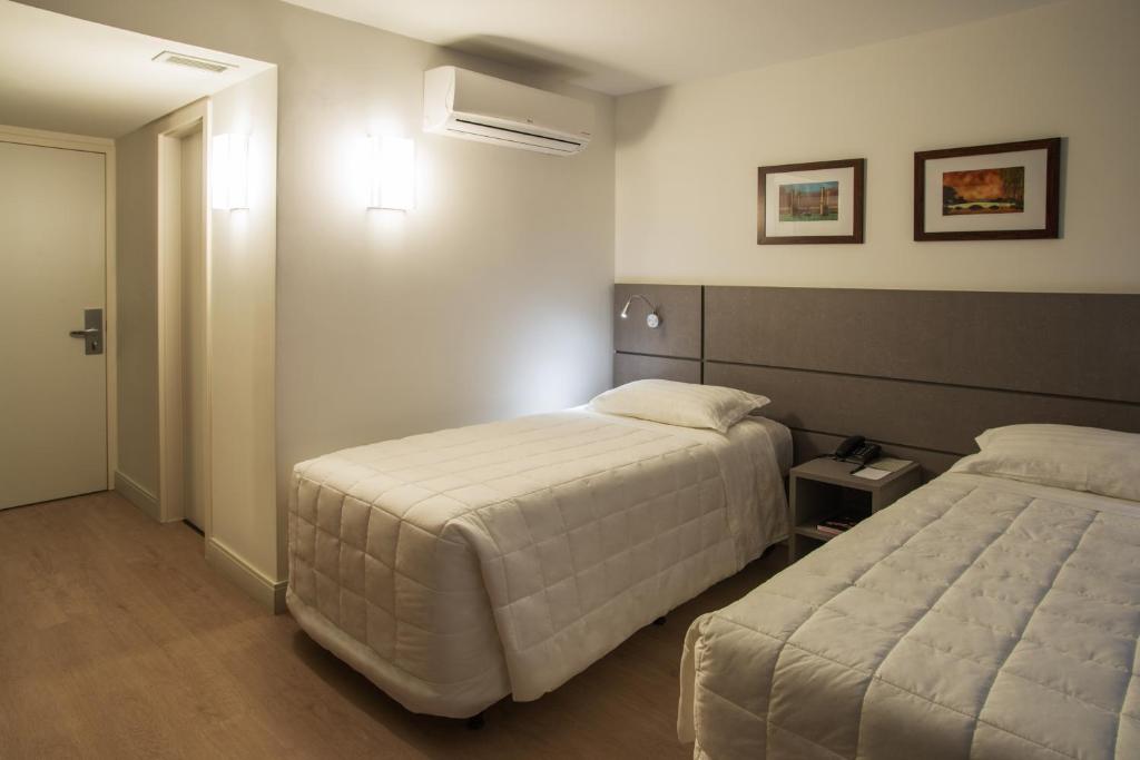 Postel nebo postele na pokoji v ubytování Hotel Laghetto Moinhos