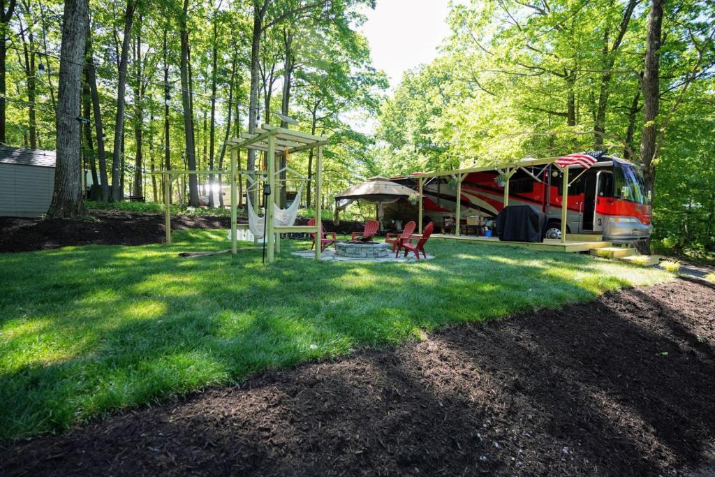a campsite with a tent and chairs in the grass at 3E *Glamping at Treasure Lake* in DuBois
