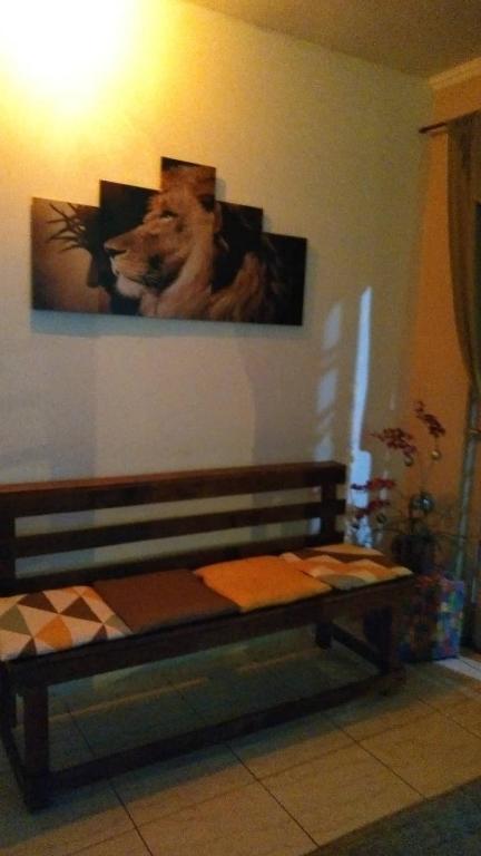 a bedroom with a picture of a dog on the wall at POUSADA GRACAS in Cachoeira Paulista