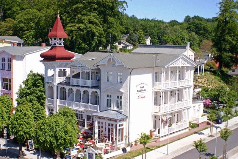 an aerial view of a large white building with a red tower at Hotel Villa Waldfrieden in Ostseebad Sellin