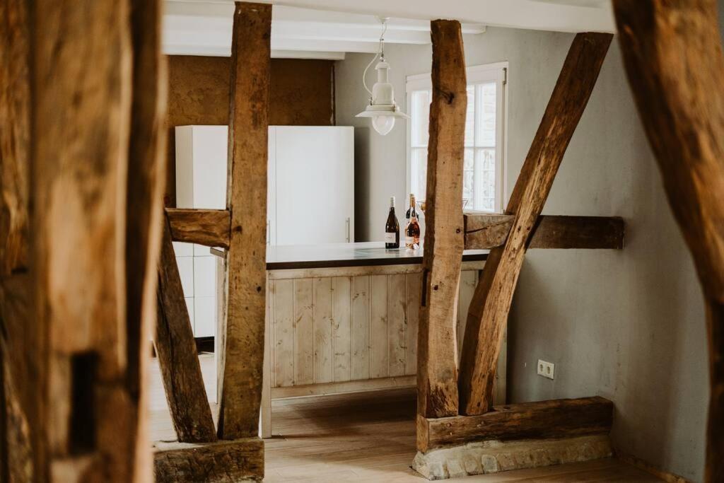 a kitchen with wooden beams and a counter at Modernisiertes Fachwerkhaus in Rheinbach bei Bonn in Rheinbach