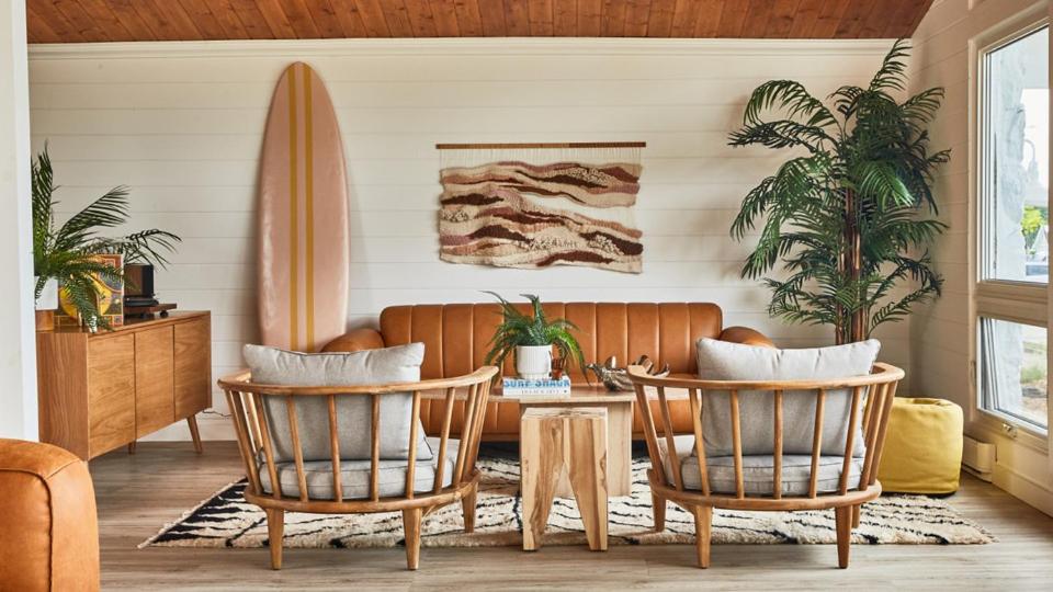 a living room with two chairs and a surfboard at The June Motel in Sauble Beach