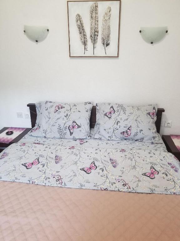a bedroom with a bed with pink butterflies on it at Apartments Beka in Žabljak