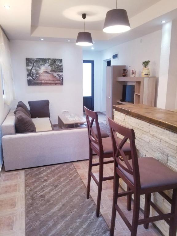 a living room with a couch and two chairs at Apartments Beka in Žabljak