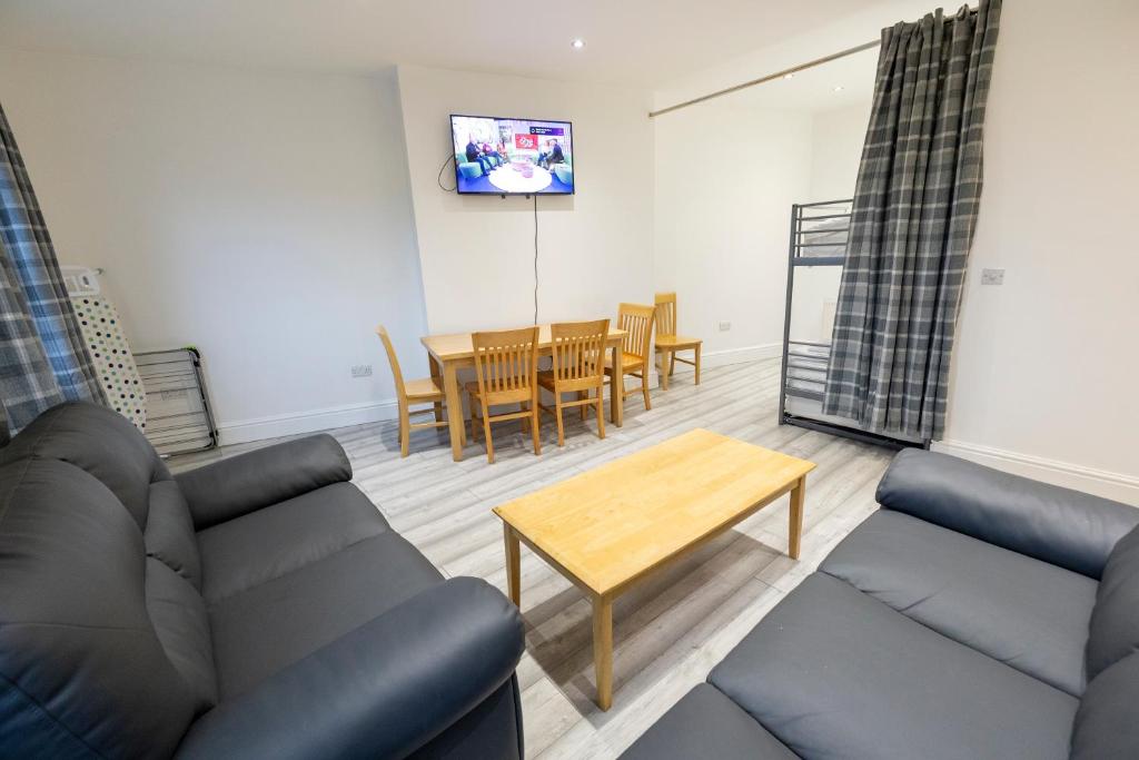 a living room with a couch and a table at Entire Two Double Bedrooms Flat with River Yare View H6 in Great Yarmouth
