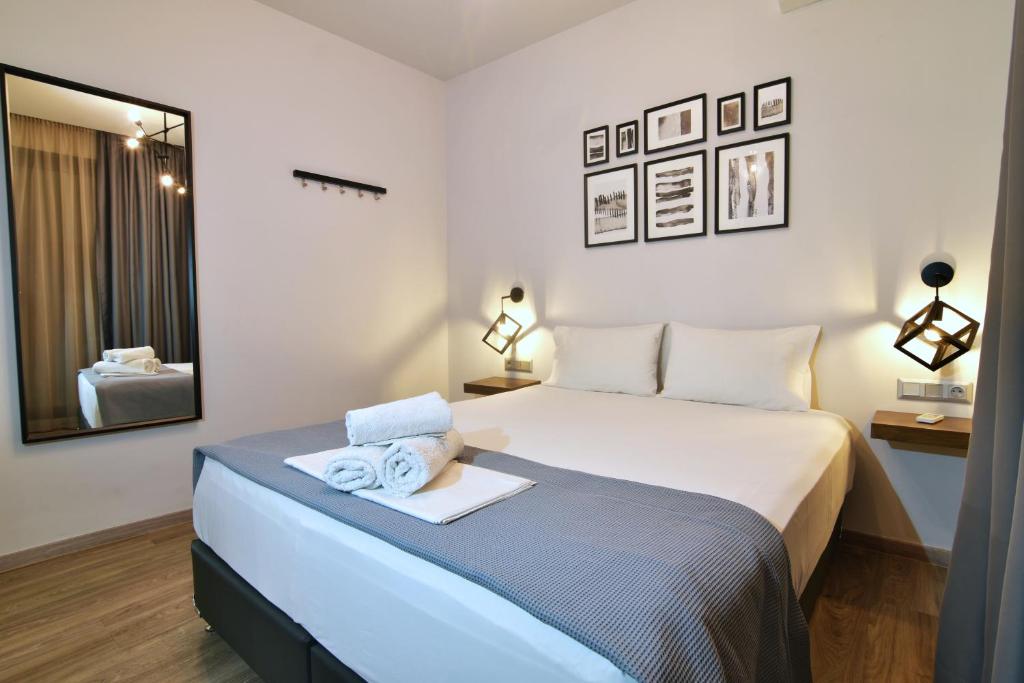 a bedroom with a bed with towels on it at Feel Athens Studios at Monastiraki in Athens