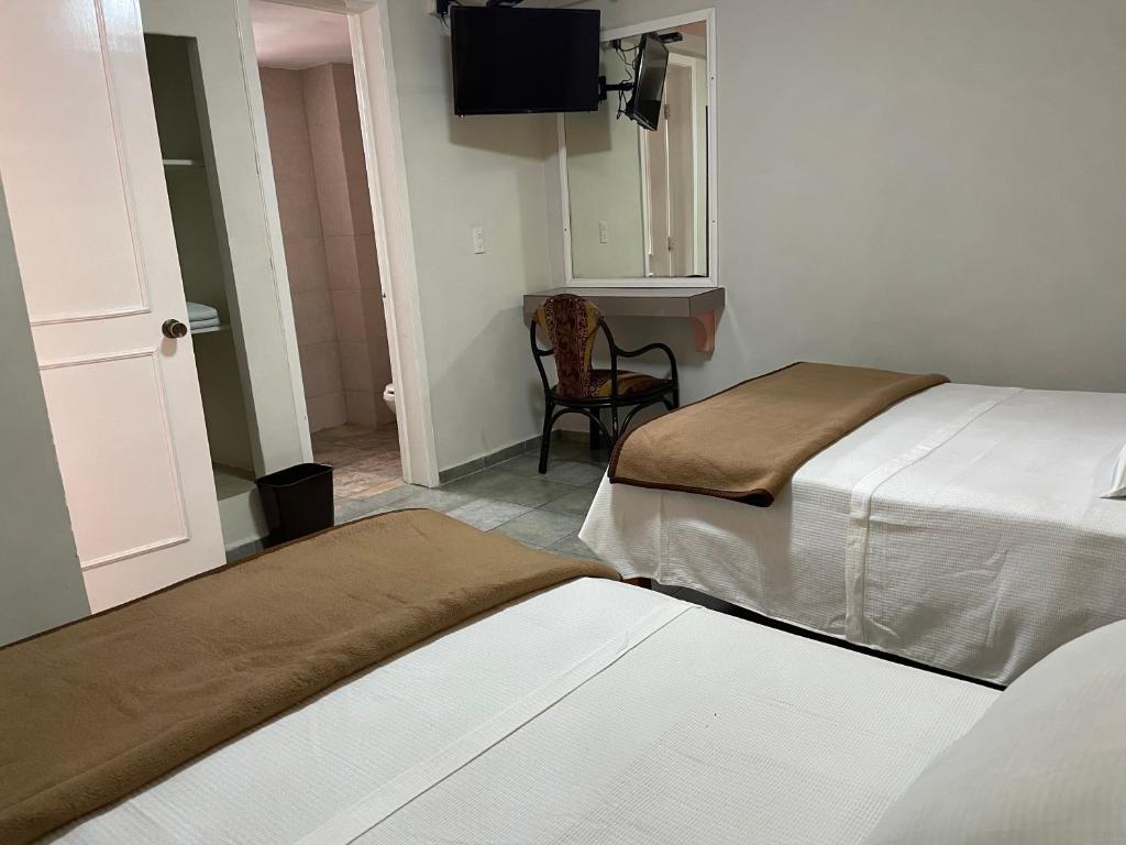 Postel nebo postele na pokoji v ubytování Hotel Rias