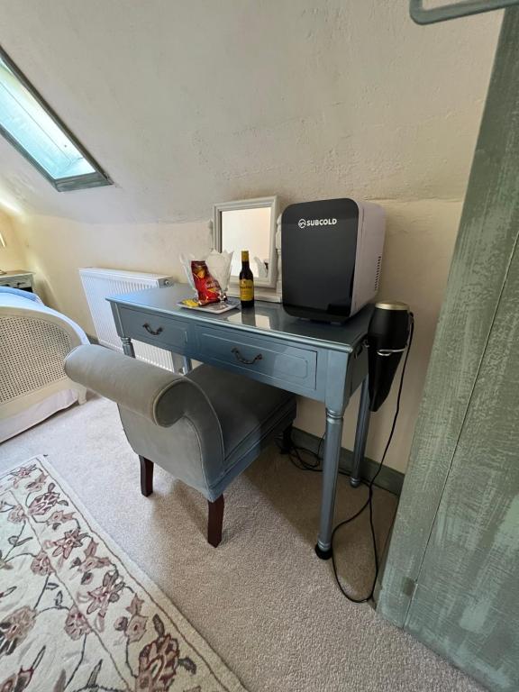 a desk with a computer on it in a room at The Tea House in Rye