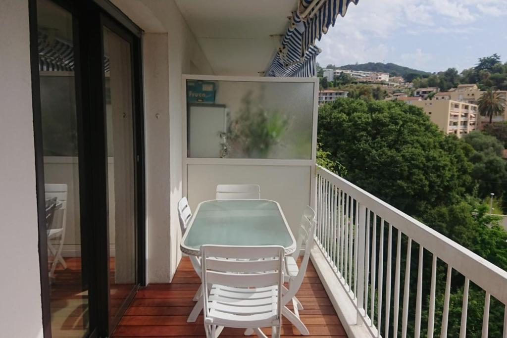 un balcon avec une table et des chaises dessus dans l'établissement Harmonieux  70 m avec BALCON vue sur la MER, à Cannes