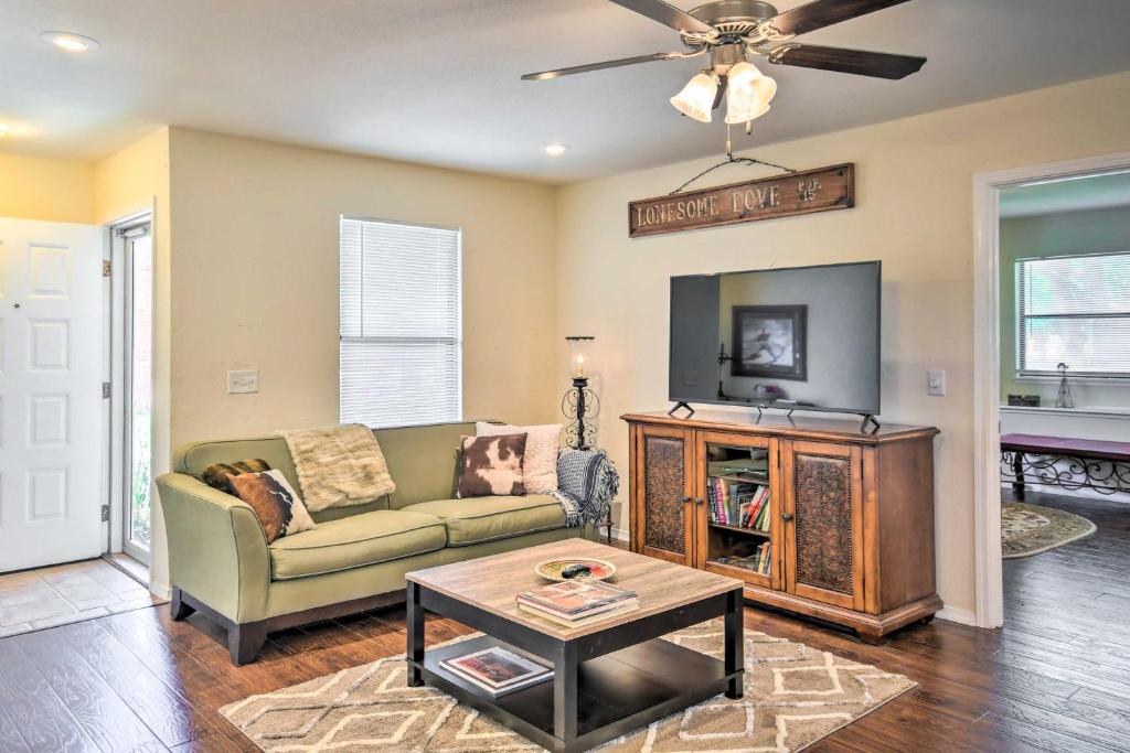 a living room with a couch and a tv at Unique Ranch-Style Home Less Than 2 Mi to Downtown! in Canyon