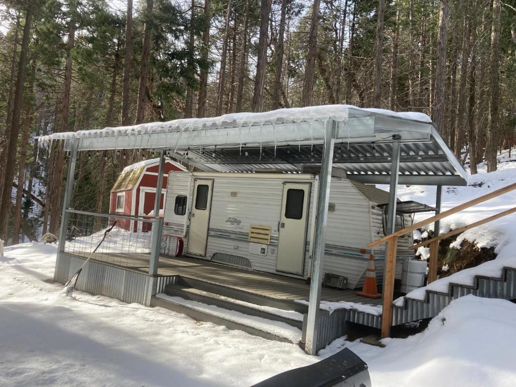 Ein Wohnwagen parkt unter einem Dach im Schnee in der Unterkunft Glamping property in Panorama Heights