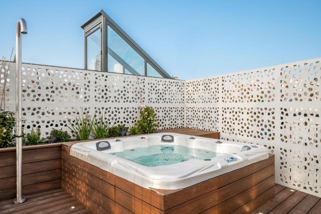 a jacuzzi tub on a wooden deck at Albi Hotel in Jerusalem