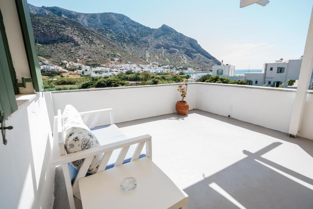 a white balcony with a view of a mountain at Oasis in Kamares