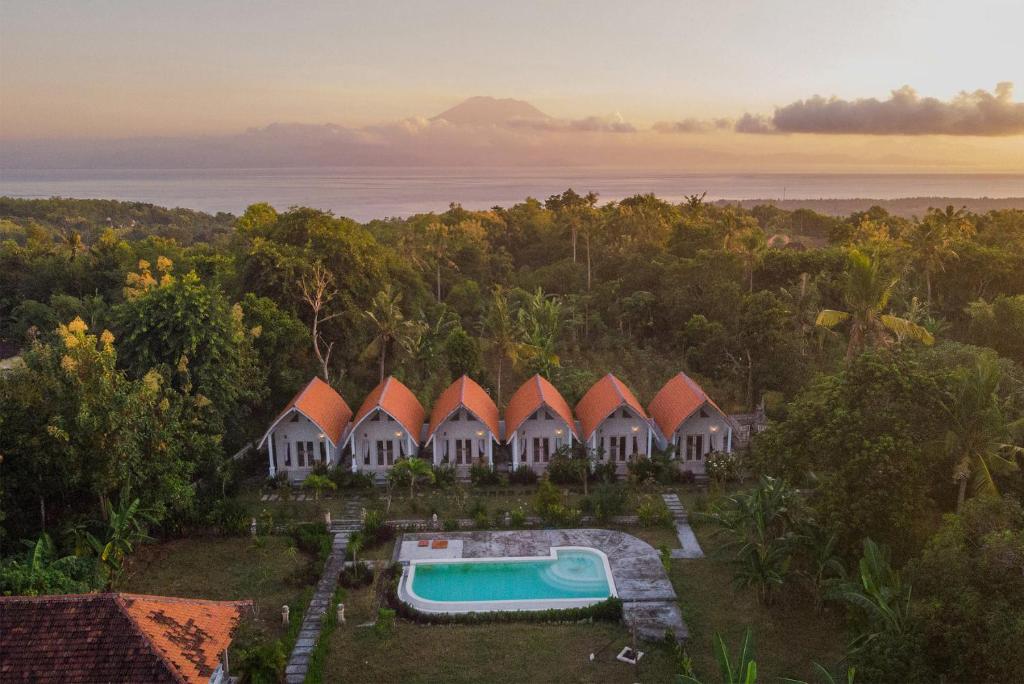an aerial view of a resort with a swimming pool at Kayu Kuning Cottage in Nusa Penida