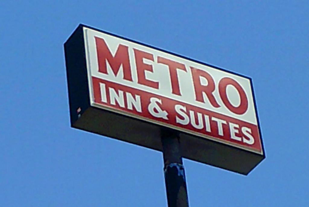 a sign for a merro incint and switches at Metro Inn & Suites in Jacksonville