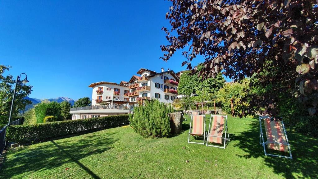 a yard with two mirrors in front of a house at La Montanina Hotel in Val di Non in Malosco