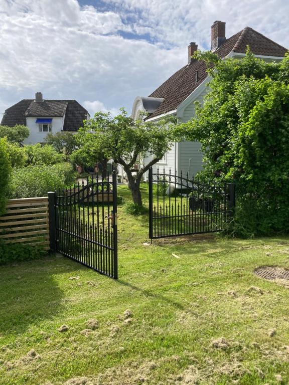 a black fence in front of a house at Bulls Haven Villa Kristiansand in Kristiansand