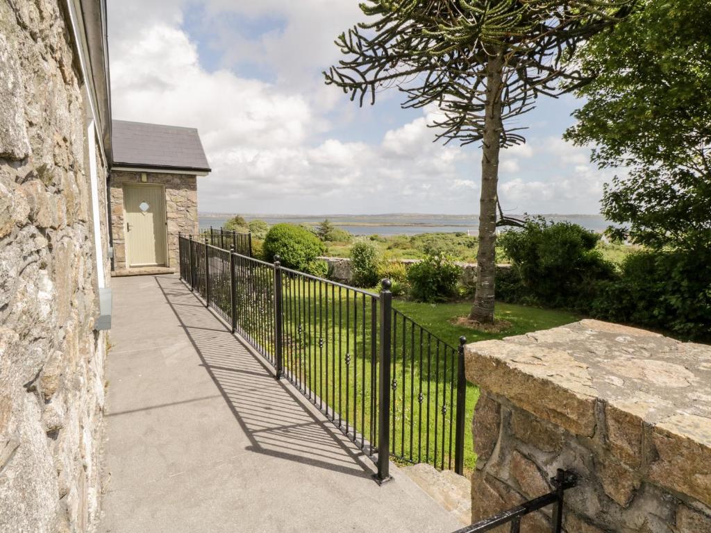 a walkway leading up to a house with a fence at Prague House in Lettermore